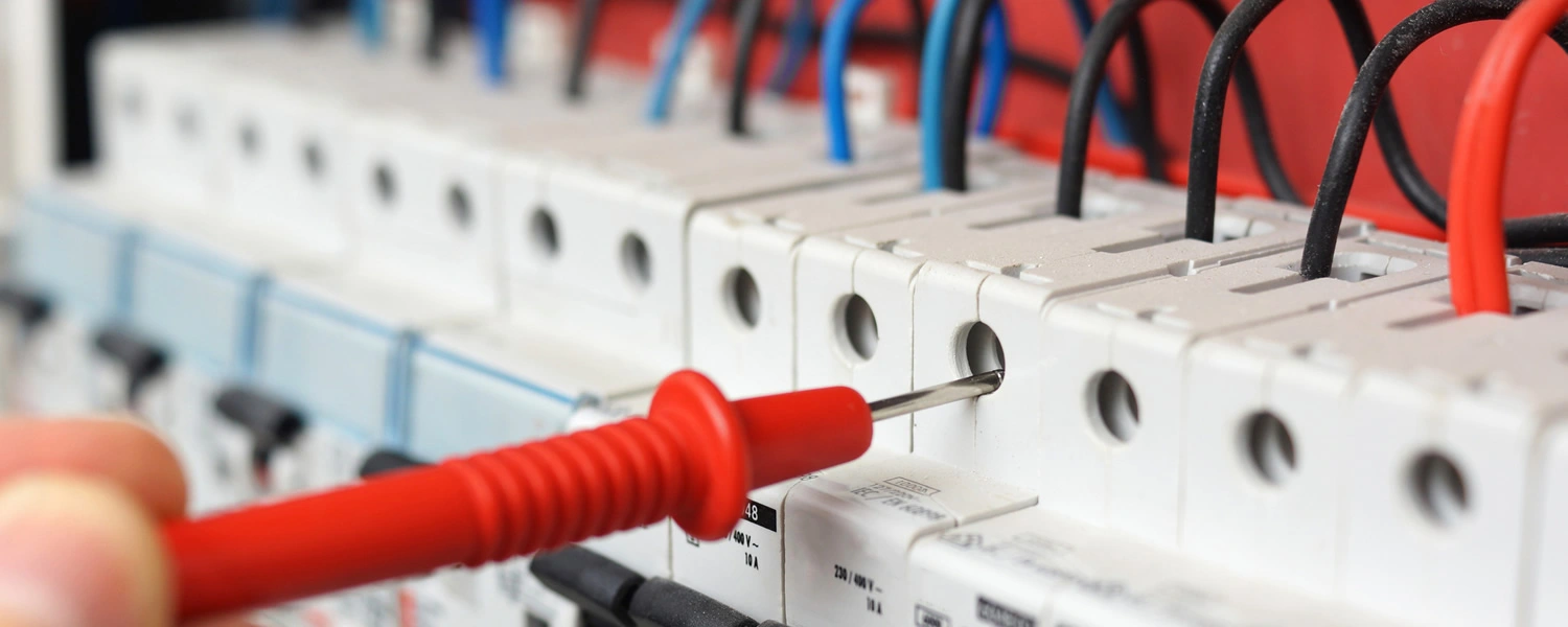 Close-up of multimeter probe in panel